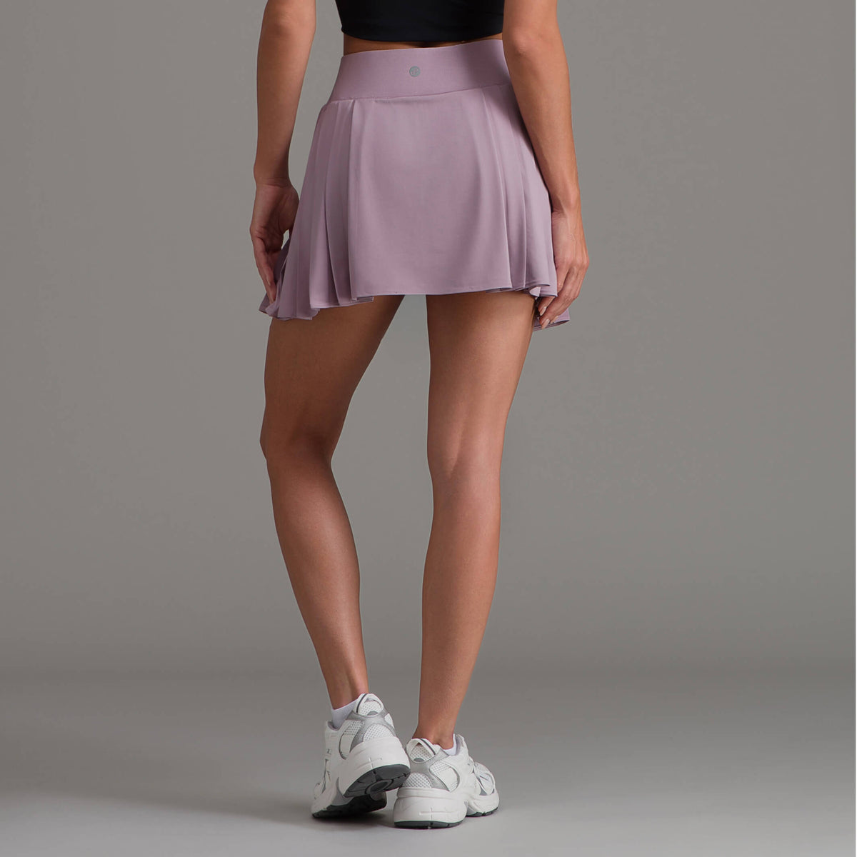 Falda corta deportiva malva plisada con dobladillo con caída y cintura entallada