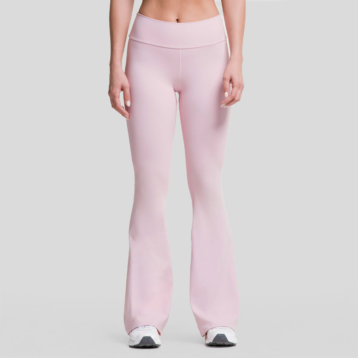 Leggings deportivos acampanados mujer rosa claro, vista frontal con costuras visibles