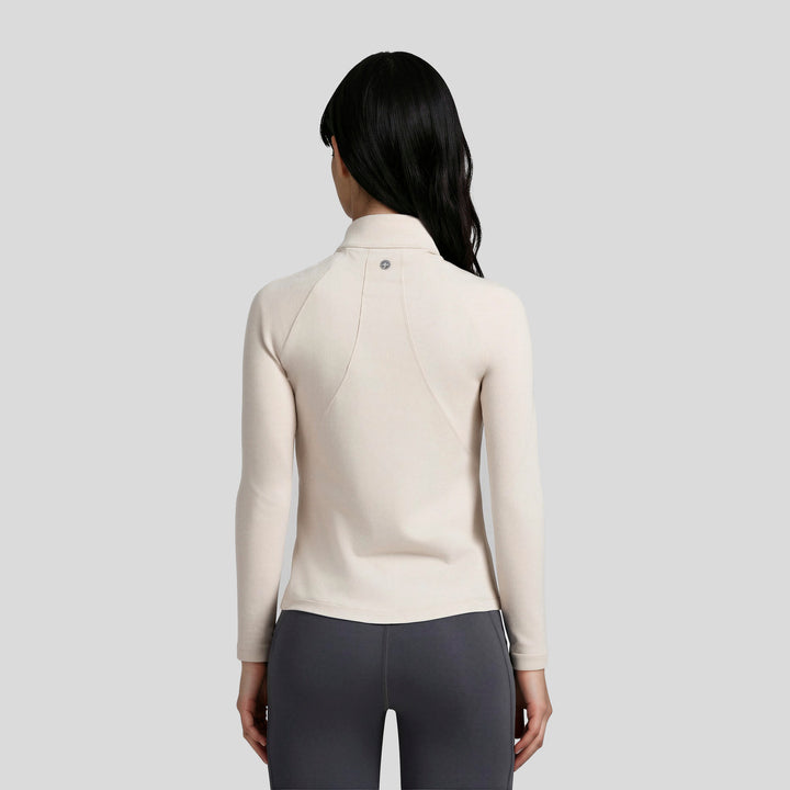 Chamarra deportiva de mujer beige vista trasera con cierre y cuello alto