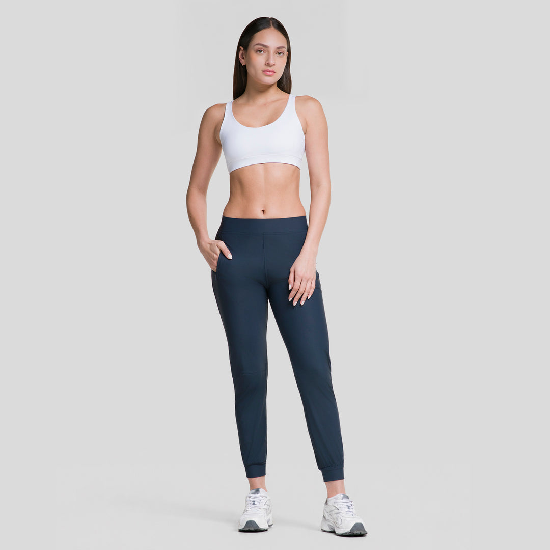 Pantalón jogger deportivo para mujer azul marino, tiro medio con puño elástico en el tobillo.