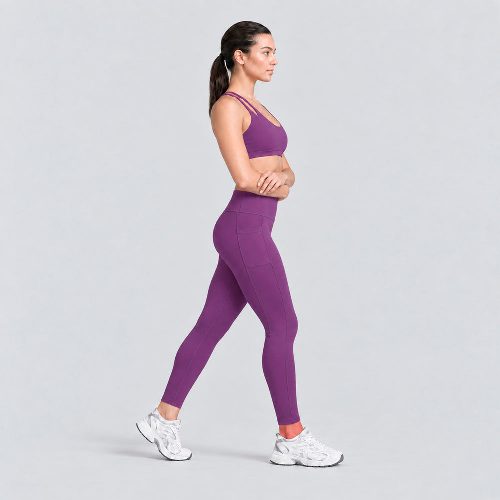 Conjunto deportivo morado visto de lado: top de tirantes dobles y legging tiro alto