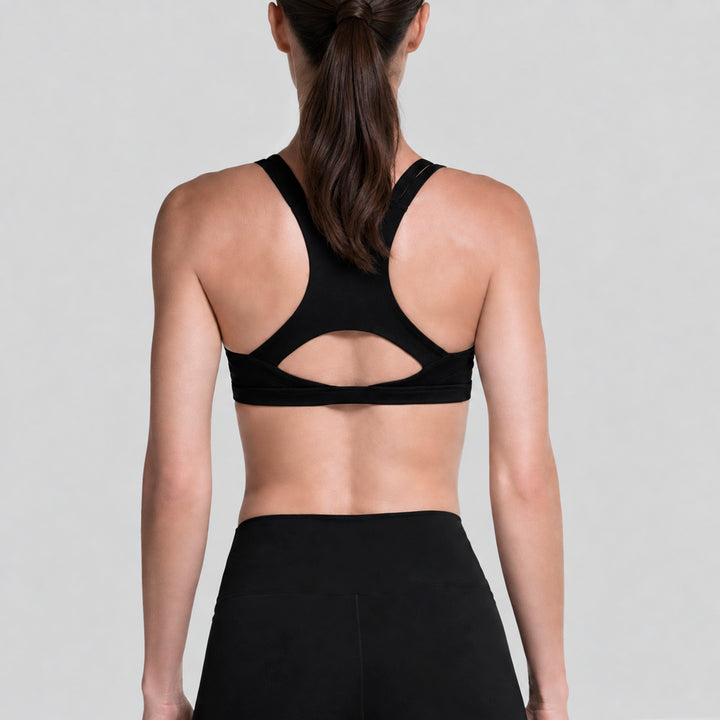Top deportivo negro con espalda cruzada y legging tiro alto, vista posterior