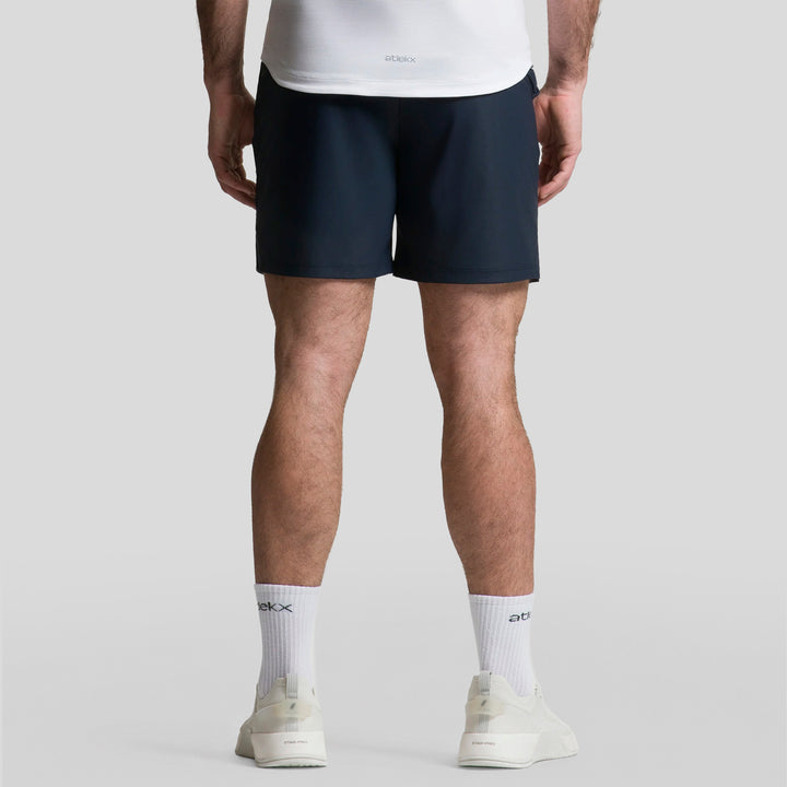 Short deportivo de hombre ATLEKX en azul oscuro, vista trasera con logo pequeño