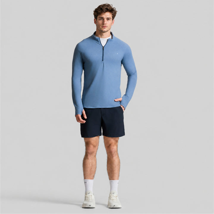 Sudadera deportiva azul para hombre con cremallera media y cuello alto.