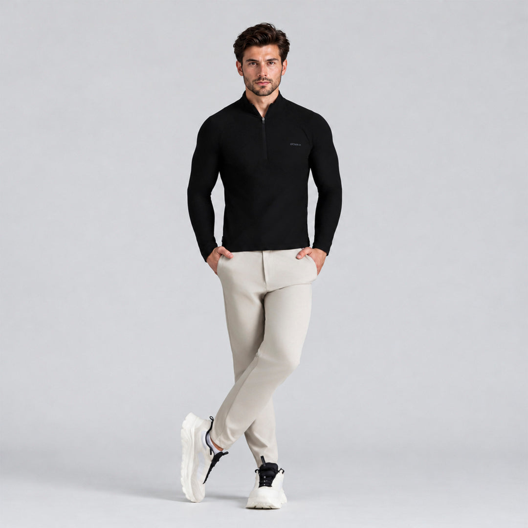 Sudadera deportiva negra para hombre con cremallera media y cuello alto.