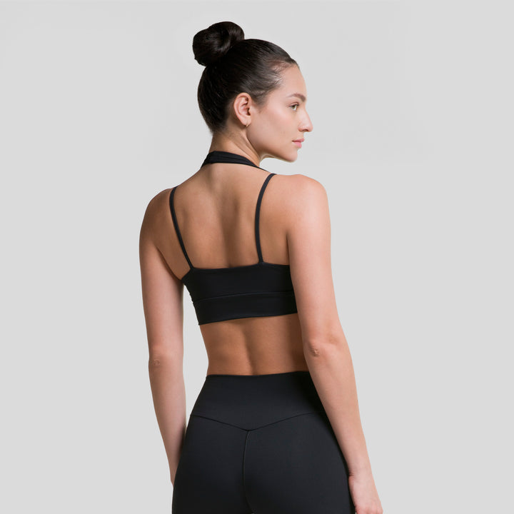 Top deportivo ATLEKX negro con espalda descubierta y tirantes, diseño escotado